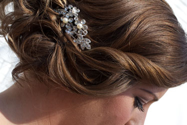 bride's hairstyle with rhinestone hair comb