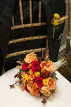 groom's tux coat with bride's bouquet